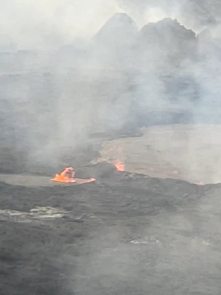 Active lava fountains erupt from a volcanic crater surrounded by volcanic landscape and steam plumes. — Hawaiʻi Volcanoes National Park, Big Island, Hawaii