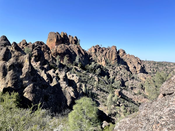 Distinctive rock pinnacles and boulders scattered across a desert hillside at Pinnacles, California, with sparse desert… — Big Sur & the Highway 1 Coast