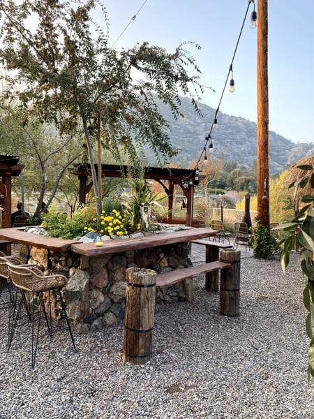 Rustic outdoor café with stone table, wooden pergolas, and mountain vista in the background near Three Rivers… — Sequoia & Kings Canyon