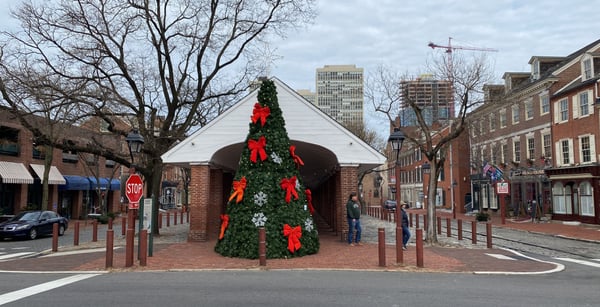 Historic brick buildings and a large decorated Christmas tree with red bows in Head House Square, Philadelphia. — Center City, Philadelphia