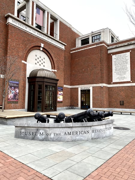 The Museum of the American Revolution building exterior with colonial-era cannons displayed in the courtyard plaza. — Museum of the American Revolution, Philadelphia