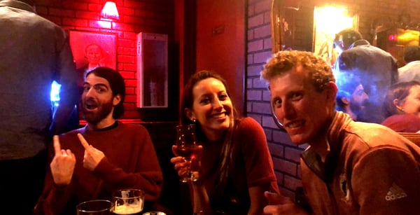 Friends enjoying drinks in a red-lit bar with neon signage on Page Street in San Francisco. — Haight-Ashbury, San Francisco