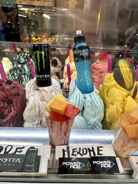 Gelato shop window display with colorful frozen desserts and beverage branding in Florence, Italy. — Oltrarno, Florence