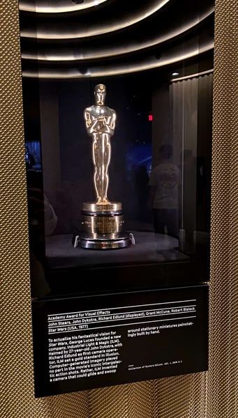 Academy Award for Visual Effects from Star Wars (1977) displayed in a museum case with detailed exhibition text. — Los Angeles