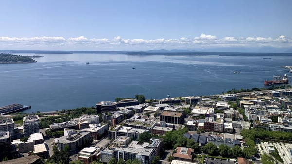Seattle waterfront and Puget Sound viewed from an elevated vantage point overlooking downtown streets and harbor. — Space Needle, Seattle