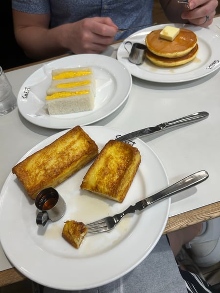 Traditional Japanese breakfast spread featuring French toast, tamagoyaki sandwich, and fluffy pancakes at a dining… — Nakagyo Ward, Kyoto