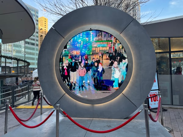 Circular illuminated art installation with LED display screen viewed from street level in downtown Philadelphia. — Center City, Philadelphia