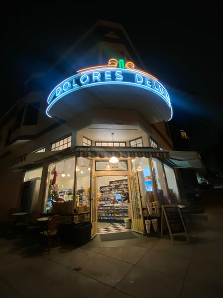Dolores Deli storefront with iconic blue neon sign photographed at night in San Francisco. — Castro District, San Francisco