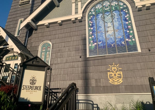 Steeple Jack Brewing Co occupies a converted church building with ornate stained glass windows in Portland, Oregon. — Kerns, Portland