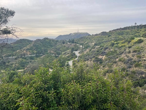 Winding river through forested hills with a distant hilltop structure visible in the background, viewed from an… — Los Angeles