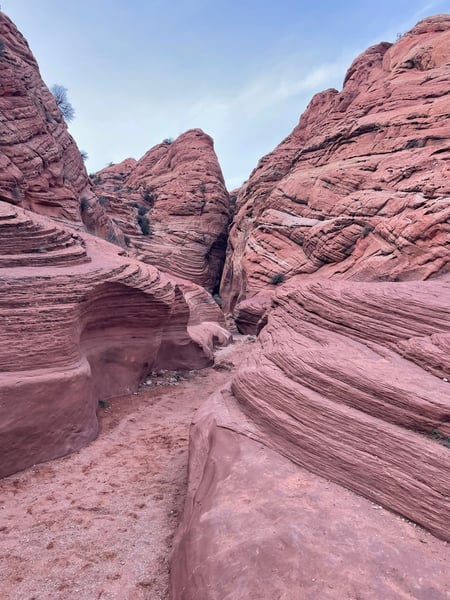 Red sandstone rock formations with layered striations viewed from a narrow canyon passage near Kanab, Utah. — The Wave Trail, Kanab & The Wave