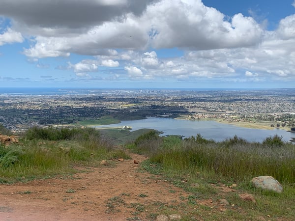 Expansive valley view with a large reservoir surrounded by suburban development, taken from an elevated hillside… — San Diego