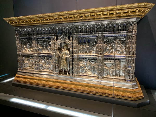 Ornate medieval gilded silver altar or shrine with intricate relief panels and decorative enamel details, displayed in… — Piazza del Duomo, Florence