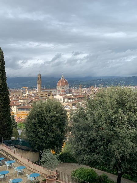 Florence Cathedral with its iconic terracotta dome viewed from a hillside vantage point with cypress trees in the… — San Niccolò, Florence
