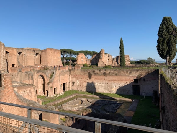 Ruins of a Roman imperial palace with brick structures and underground chambers viewed from an elevated walkway in Rome. — Campitelli, Rome