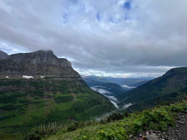 Mountain valley with layered ridges and a river winding through forested terrain, viewed from an elevated hiking… — Highline Trail, Glacier National Park